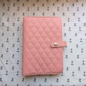 Pink quilted leather travel jewelry book with zipper pockets